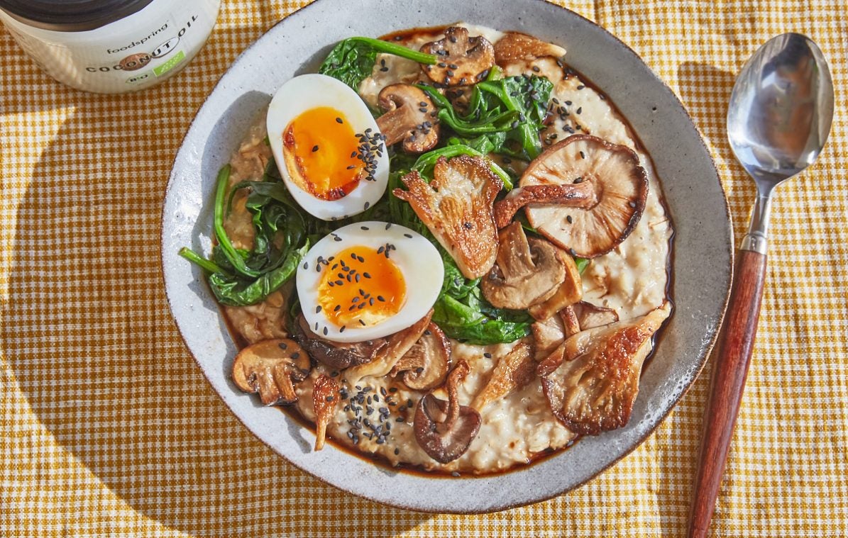 savoury oatmeal in a bowl topped with soft boiled egg, mushrooms and spinach